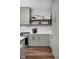 Kitchen with sage green cabinets, open shelving, stainless steel appliances and wood floors at 1461 Whistle Way, Westfield, IN 46074