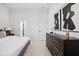 Main bedroom with ensuite bathroom and large dresser with modern art hanging above at 1461 Whistle Way, Westfield, IN 46074