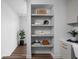 Hallway niche with stylish decorative objects on floating shelves, next to office and plant at 1461 Whistle Way, Westfield, IN 46074
