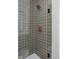 Tile shower with a rainfall shower head, bronze fixtures, and a glass door enclosure at 1461 Whistle Way, Westfield, IN 46074
