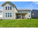 Home's backyard featuring a covered patio with an outdoor seating area and a well maintained lawn at 15813 Arthur Jacob Ln, Noblesville, IN 46060