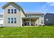 Expansive backyard with covered patio, lush green lawn and home exterior at 15813 Arthur Jacob Ln, Noblesville, IN 46060