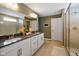 Bathroom with double sinks, sleek counter tops, white cabinetry, and walk in glass shower at 15813 Arthur Jacob Ln, Noblesville, IN 46060