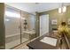 Bathroom featuring a glass shower with a built in seat, sleek counter top, and modern light fixture at 15813 Arthur Jacob Ln, Noblesville, IN 46060