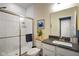 Well-lit bathroom with tiled shower, modern vanity with dark countertop, and framed mirror provides a clean aesthetic at 15813 Arthur Jacob Ln, Noblesville, IN 46060