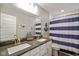 Well-lit bathroom with double vanity, gray countertop, and nautical-themed decor at 15813 Arthur Jacob Ln, Noblesville, IN 46060