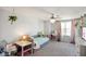 Bright bedroom with a charming bed, decorative fan and adjacent sitting and desk area at 15813 Arthur Jacob Ln, Noblesville, IN 46060