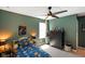 Green-toned bedroom with gray carpet, fan, and ample natural light from an adjacent window at 15813 Arthur Jacob Ln, Noblesville, IN 46060