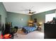 Space themed bedroom with dark green walls, space bedding, and ceiling fan at 15813 Arthur Jacob Ln, Noblesville, IN 46060