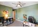 Comfortable room boasts stylish ceiling fan, desk, shelving, and a bright, inviting ambiance at 15813 Arthur Jacob Ln, Noblesville, IN 46060