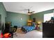 Comfortable bedroom with sleek ceiling fan, a corner desk, and a soft carpet at 15813 Arthur Jacob Ln, Noblesville, IN 46060