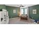 Relaxing green bedroom featuring a cozy sitting area with comfortable chair and accent pillows at 15813 Arthur Jacob Ln, Noblesville, IN 46060