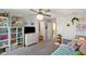 Bright bedroom with playful decor, storage shelves, and a connecting bathroom at 15813 Arthur Jacob Ln, Noblesville, IN 46060