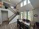 Open dining room featuring hardwood floors, a large window, and seating for six at 15813 Arthur Jacob Ln, Noblesville, IN 46060