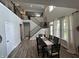 Open dining room featuring hardwood floors, a large window with natural light, and seating for six at 15813 Arthur Jacob Ln, Noblesville, IN 46060