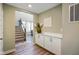 Welcoming entryway with stairs and built-in cabinets, a decorative table and hardwood floors at 15813 Arthur Jacob Ln, Noblesville, IN 46060
