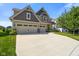 Attractive home with a spacious driveway and a well-kept lawn. A three car garage adds convenience at 15813 Arthur Jacob Ln, Noblesville, IN 46060