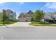 Charming two-story home with three-car garage and landscaped yard on a sunny day at 15813 Arthur Jacob Ln, Noblesville, IN 46060