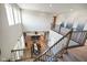 Bright, open-concept foyer showcasing a dining table, gourmet kitchen, and carpeted staircase with wooden railing at 15813 Arthur Jacob Ln, Noblesville, IN 46060