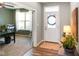 Inviting foyer with hardwood floors, leading to an office with glass doors and ample natural light at 15813 Arthur Jacob Ln, Noblesville, IN 46060