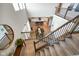Open-concept foyer showcasing a dining table, gourmet kitchen, and carpeted staircase with wooden railing at 15813 Arthur Jacob Ln, Noblesville, IN 46060