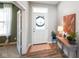Bright foyer featuring hardwood floors, a decorated front door, and a stylish console table at 15813 Arthur Jacob Ln, Noblesville, IN 46060