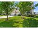 Landscaped front yard with green grass and two shade trees accentuating the two-story home at 15813 Arthur Jacob Ln, Noblesville, IN 46060