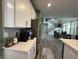 Open-concept kitchen showcasing white cabinetry, quartz counters, stainless steel appliances, and a view of the staircase at 15813 Arthur Jacob Ln, Noblesville, IN 46060