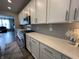 Modern kitchen featuring sleek white cabinets, stainless steel appliances, quartz countertops, and stylish gray backsplash at 15813 Arthur Jacob Ln, Noblesville, IN 46060