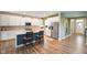 Modern kitchen boasts white cabinets, stainless steel appliances, and a blue island with seating at 15813 Arthur Jacob Ln, Noblesville, IN 46060