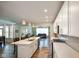 Open concept: Modern kitchen with white cabinets flows into the living room at 15813 Arthur Jacob Ln, Noblesville, IN 46060