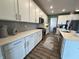 Well-lit kitchen features stainless steel appliances, abundant white cabinetry, and hardwood floors at 15813 Arthur Jacob Ln, Noblesville, IN 46060