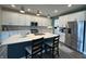 Modern kitchen featuring an island with seating, stainless steel appliances, recessed lighting, and wood floors at 15813 Arthur Jacob Ln, Noblesville, IN 46060