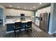 Beautiful kitchen with a large island, stainless steel appliances, modern lighting, and quartz countertops at 15813 Arthur Jacob Ln, Noblesville, IN 46060