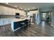 Stylish kitchen featuring an island with seating, white cabinets, stainless appliances, and a view to the entry at 15813 Arthur Jacob Ln, Noblesville, IN 46060