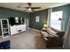 Living room featuring a couch, TV, and bright natural light with a ceiling fan at 15813 Arthur Jacob Ln, Noblesville, IN 46060