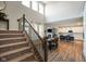 Open-concept living space with hardwood floors, fireplace, and seamlessly connected dining area and kitchen at 15813 Arthur Jacob Ln, Noblesville, IN 46060