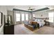 This relaxing bedroom boasts a decorative ceiling fan, comfy seating area and lots of light at 15813 Arthur Jacob Ln, Noblesville, IN 46060