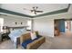Spacious main bedroom has decorative fan, comfy seating area, and bright, airy ambiance at 15813 Arthur Jacob Ln, Noblesville, IN 46060