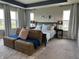 Main bedroom boasts a king bed, lounge seating, neutral paint, and carpeting at 15813 Arthur Jacob Ln, Noblesville, IN 46060