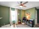 Bright home office space featuring natural light, a modern ceiling fan, and comfortable carpet at 15813 Arthur Jacob Ln, Noblesville, IN 46060