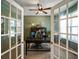 Stylish office with french doors, a ceiling fan, and a well-organized bookshelf at 15813 Arthur Jacob Ln, Noblesville, IN 46060