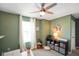 Green home office featuring a printer, colorful decor, and large ceiling fan at 15813 Arthur Jacob Ln, Noblesville, IN 46060