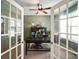 Private office with French doors, a ceiling fan, and a large desk at 15813 Arthur Jacob Ln, Noblesville, IN 46060
