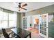 Bright office featuring a large window, french doors, and sleek ceiling fan at 15813 Arthur Jacob Ln, Noblesville, IN 46060