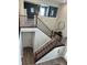 View of staircase featuring brown railings and a carpeted stairway with a decorative side table at 15813 Arthur Jacob Ln, Noblesville, IN 46060