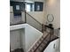 View of staircase featuring brown railings and a carpeted stairway with a decorative side table at 15813 Arthur Jacob Ln, Noblesville, IN 46060