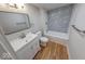 Bathroom featuring a combination shower and tub, a single sink vanity, and wood floors at 1641 Deloss St, Indianapolis, IN 46201