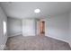 Spacious bedroom featuring neutral gray walls, carpeted floors, recessed lighting, and bright windows at 1641 Deloss St, Indianapolis, IN 46201