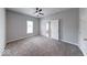 This bedroom has gray walls, a ceiling fan, neutral carpet and a view into an adjoining bedroom at 1641 Deloss St, Indianapolis, IN 46201